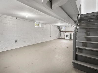 a white room with a staircase and a white wall