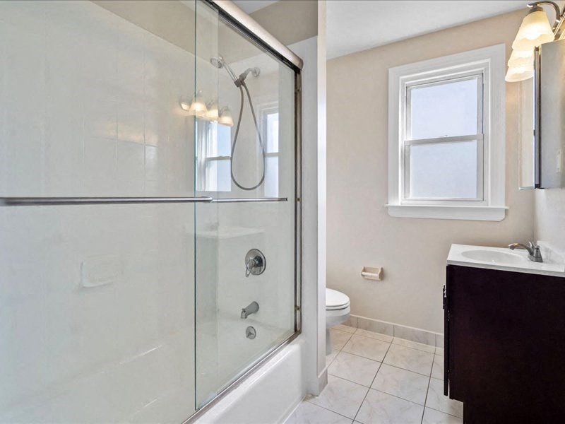 a bathroom with a shower and a sink and a toilet