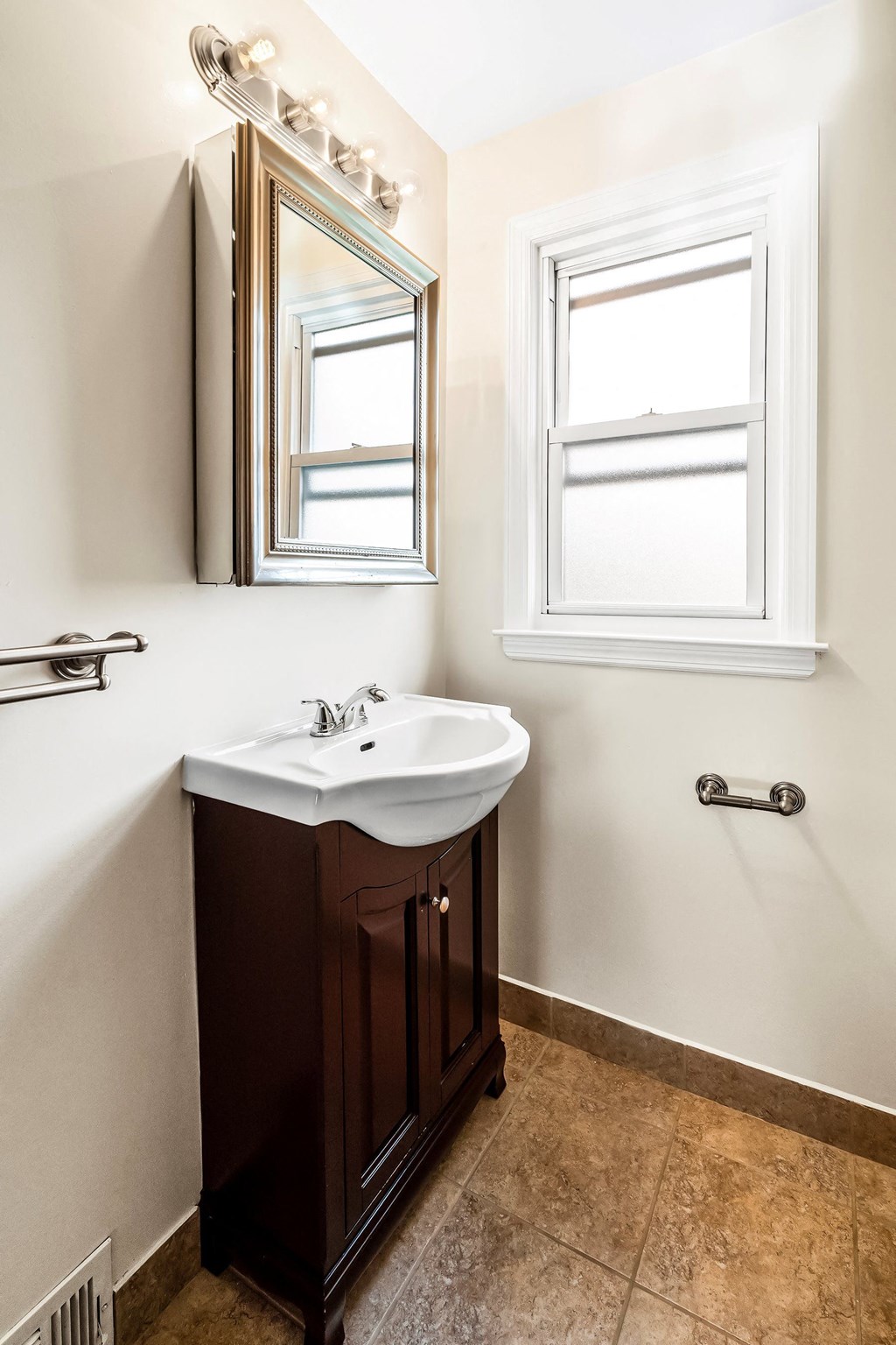 a small bathroom with a sink and a mirror