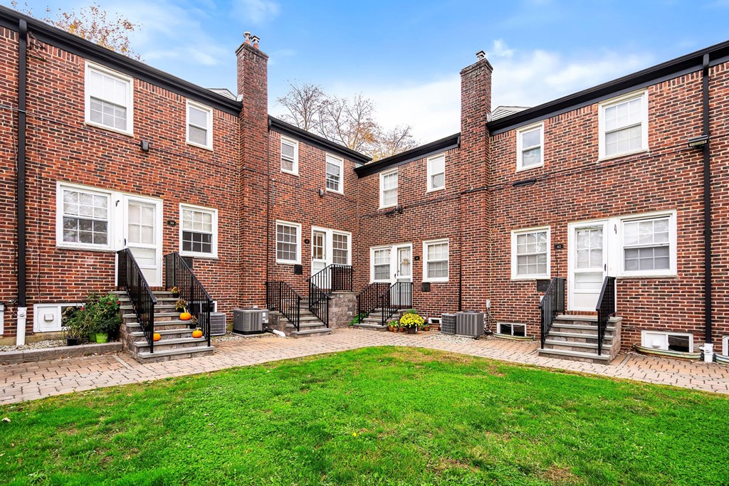 a brick building with a lawn in front of it