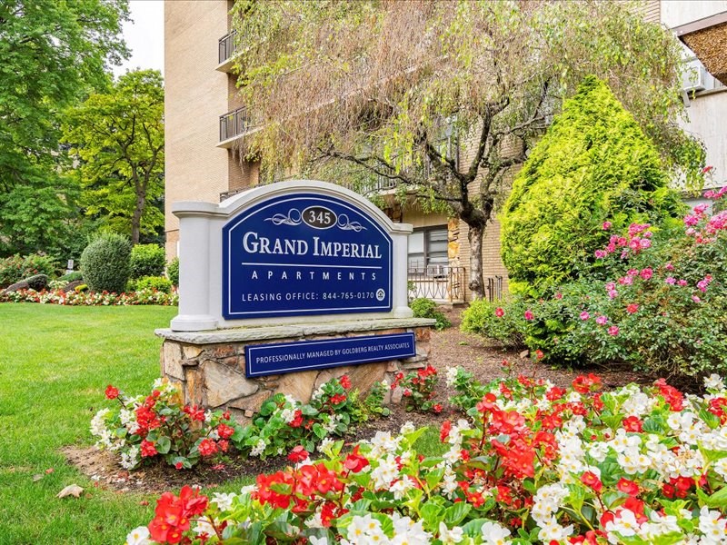 our sign in front of our building with flowers on the ground