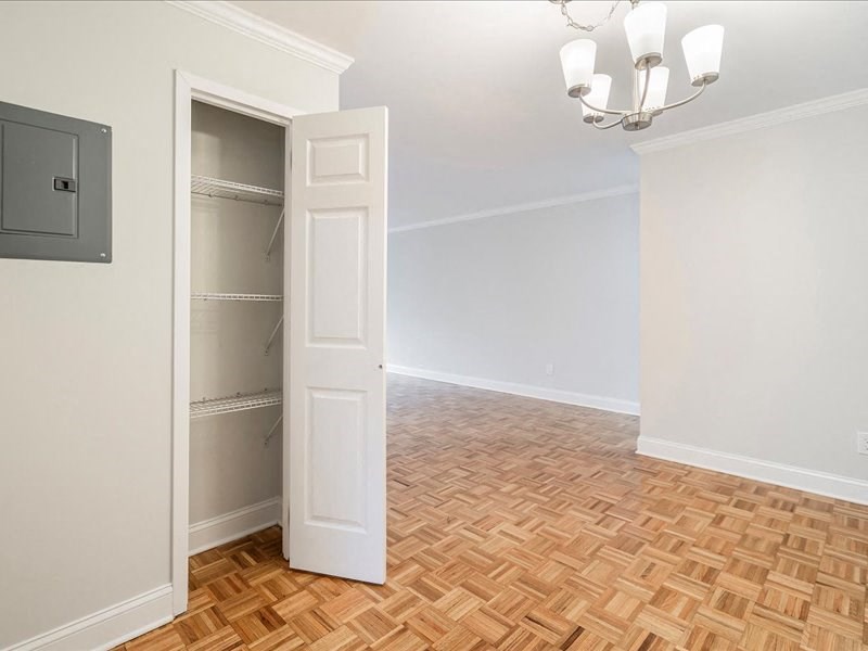 an empty living room with an open closet door