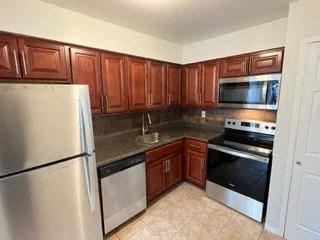 a kitchen with wooden cabinets and stainless steel appliances
