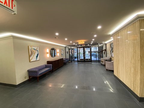 the lobby of a building with benches and chairs