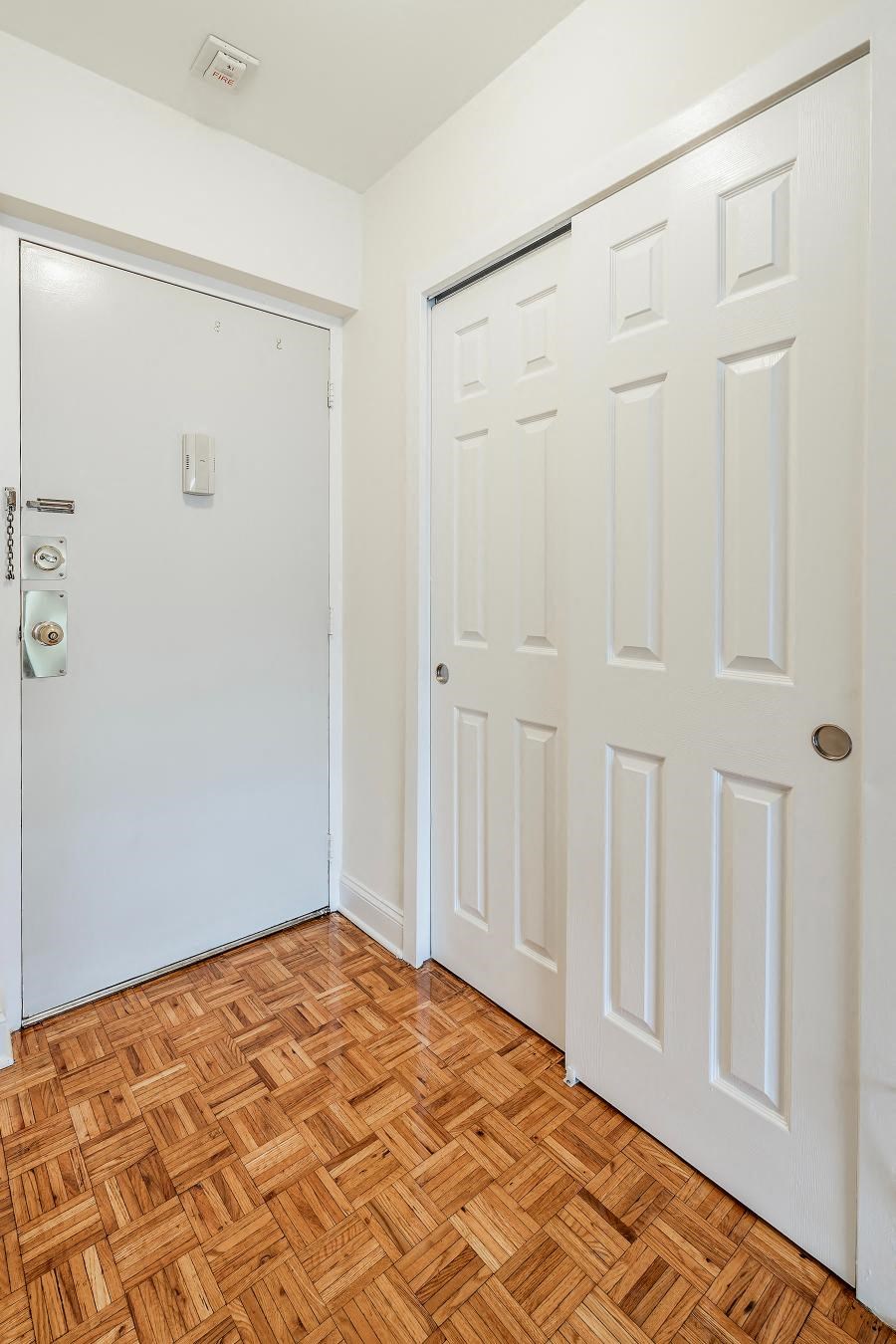 a room with two white doors and a wood floor