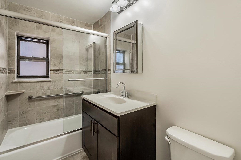 a bathroom with a sink toilet and a shower