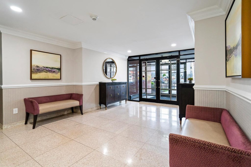 a lobby with couches and chairs and a door to a patio