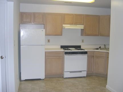 a kitchen with a stove and a refrigerator