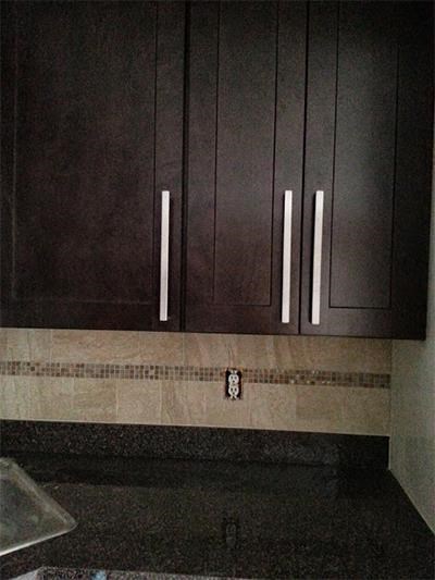 a kitchen with brown cabinets and a sink