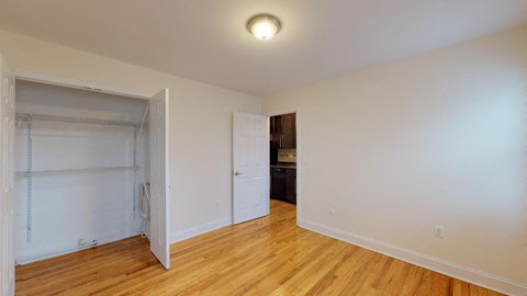 a bedroom with a closet and a door to a bathroom