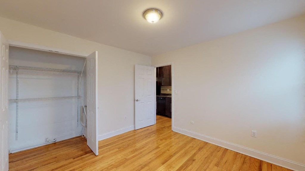 a bedroom with a closet and a door to a bathroom