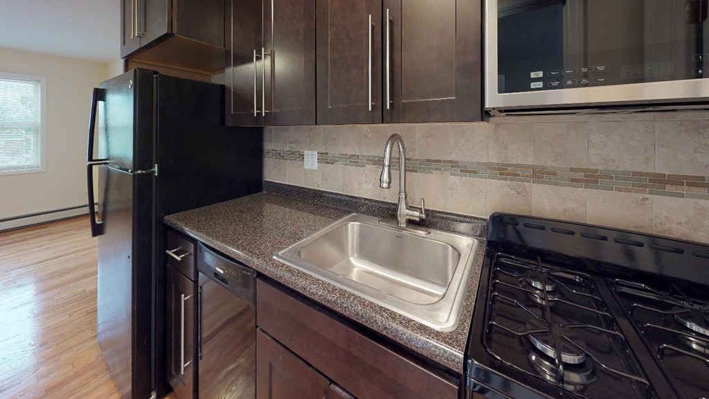 a kitchen with a sink and a refrigerator