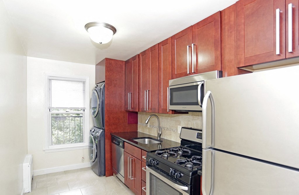 a kitchen with stainless steel appliances and wooden cabinets
