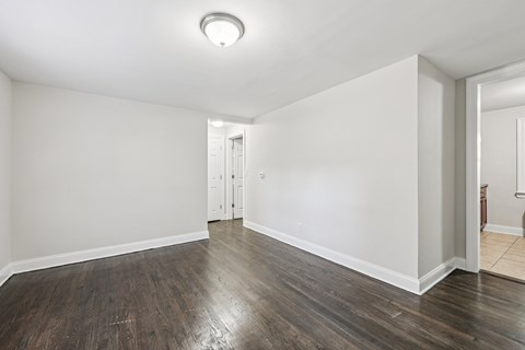 A room with a wooden floor and white walls.
