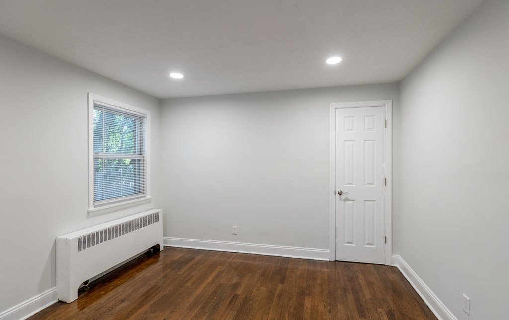 an empty room with white walls and a white door