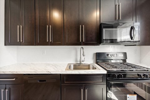 a kitchen with stainless steel appliances and wooden cabinets