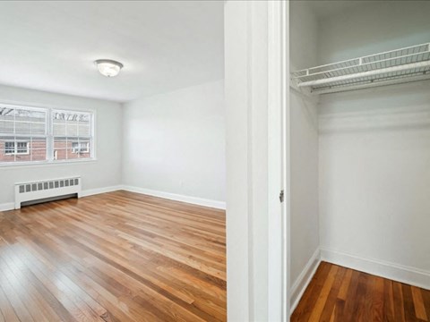 A room with wooden floors and white walls.