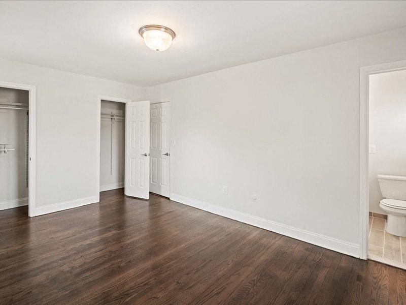 A room with white walls and wood flooring.