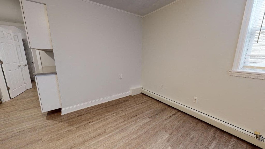 the living room of an empty house with a wooden floor