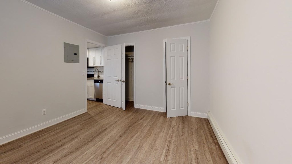 a bedroom with a door open to a kitchen
