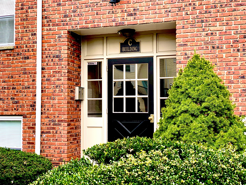 a red brick building with a black door