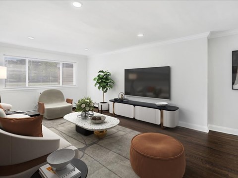A living room with a brown chair and a white sofa.