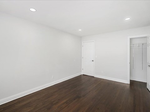 A room with wooden floors and white walls.