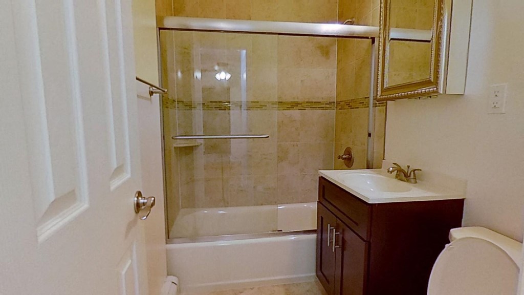 a bathroom with a sink toilet and a shower