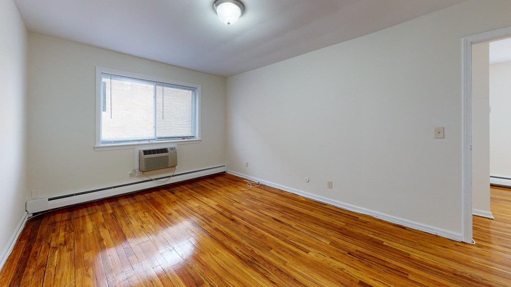 a living room with wood floors and a window