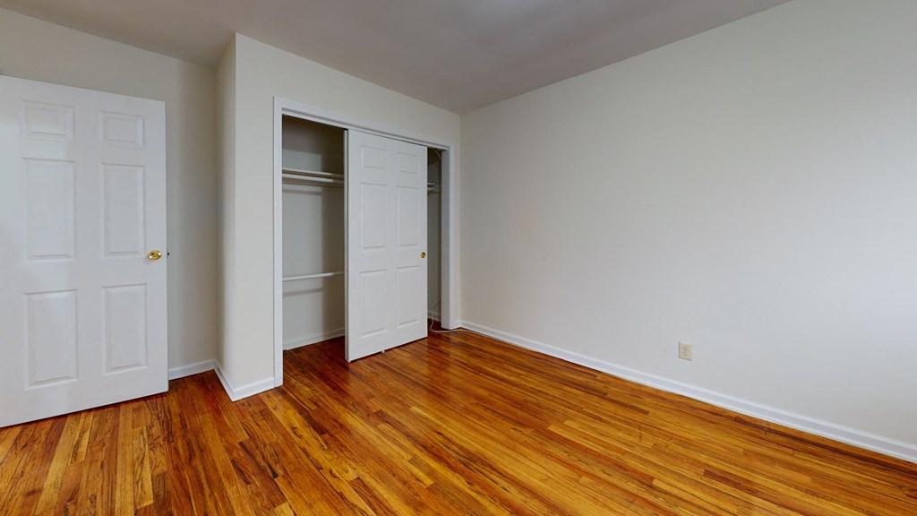 a living room with wood floors and white doors