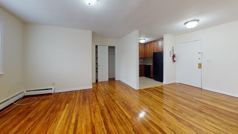 an empty living room with a hard wood floor