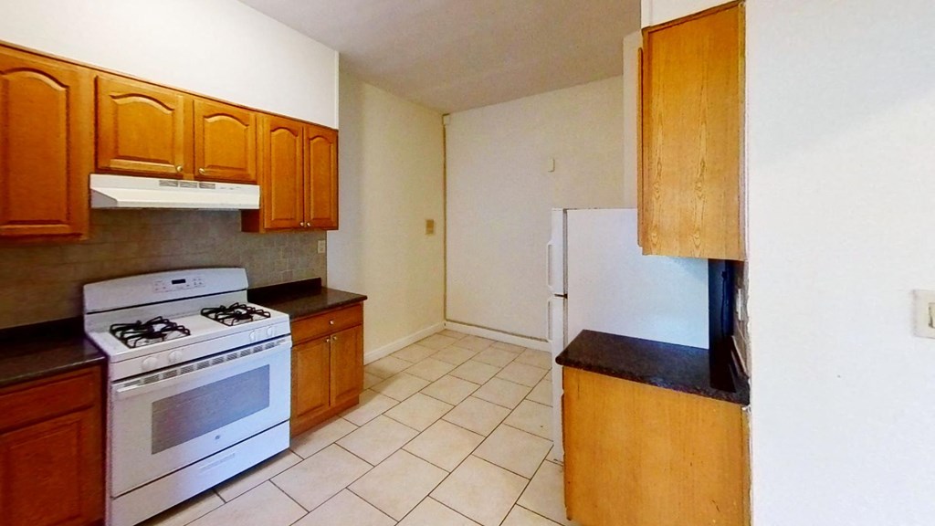 a kitchen with a stove and a refrigerator