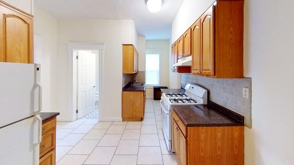 a kitchen with a stove and a refrigerator