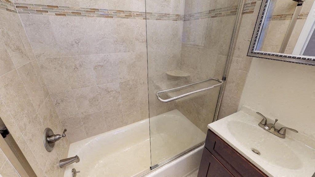 a small bathroom with a shower and a sink