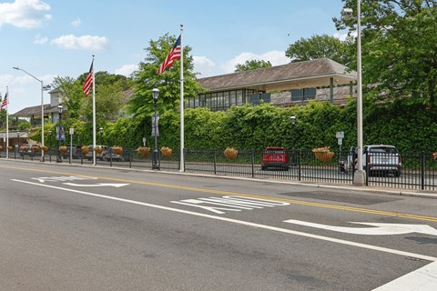 A street with a white line in the middle and a building in the background.