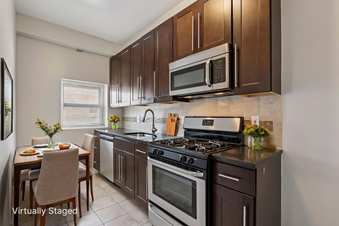 A kitchen with a stove top oven and microwave.
