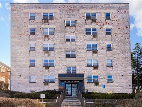 A tall building with a blue entrance and windows.