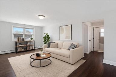 A living room with a white couch, a coffee table, and a plant.