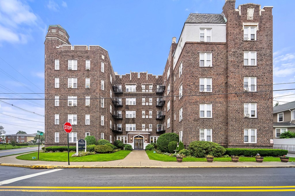 a large brick building with a stop sign in front of it
