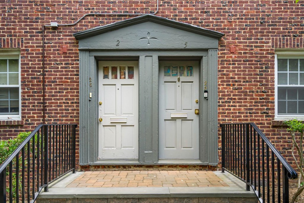 a red brick building with two white doors