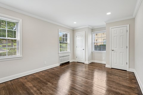 A room with wooden floors and white walls.