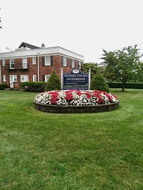 a garden of flowers in front of a building