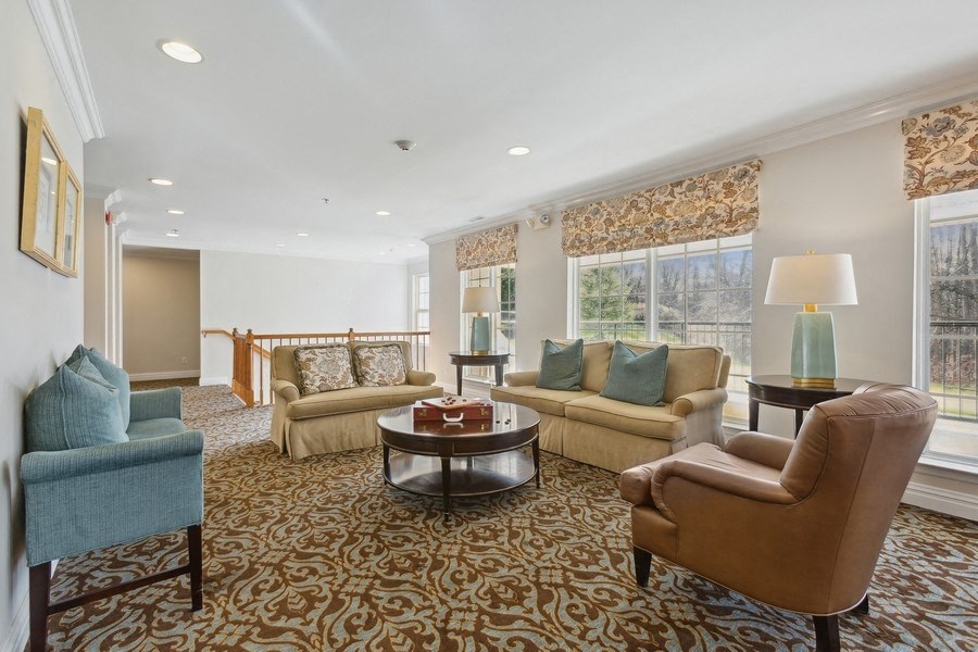 a living room with couches and chairs and a table