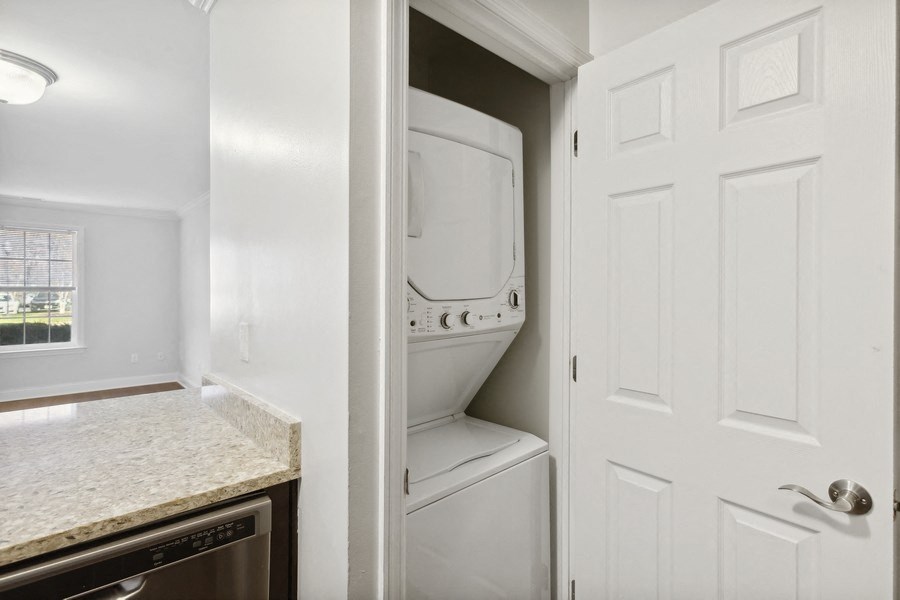 a laundry room with a white door and a washer and dryer