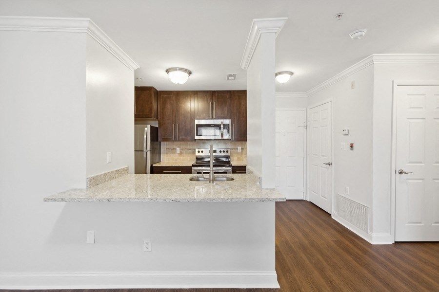 a renovated kitchen with white walls and granite counter tops