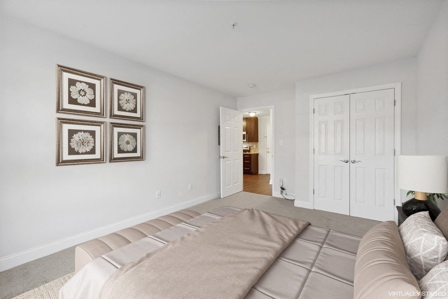 a bedroom with a large bed and a door to a bathroom