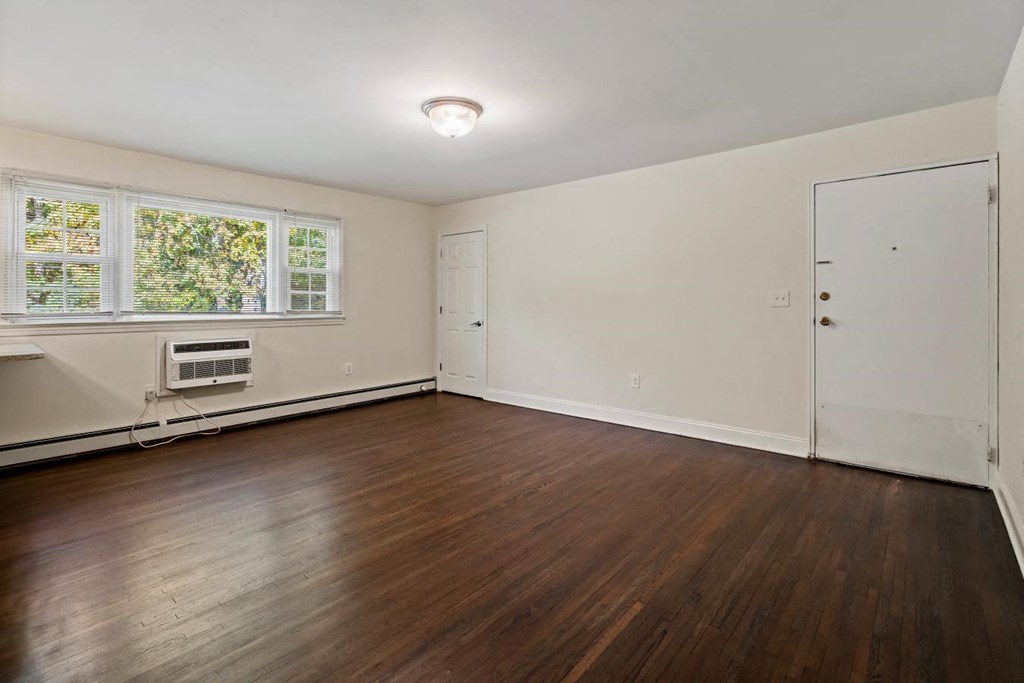 the living room of an empty house with wood floors