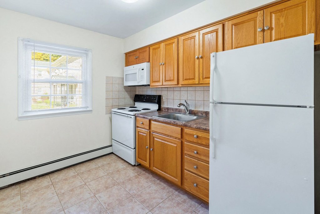 a kitchen with a stove refrigerator and sink