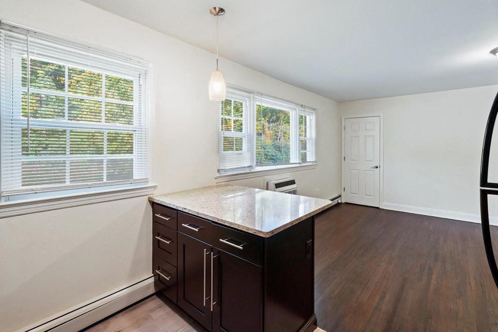 an empty kitchen with a large window and a counter top