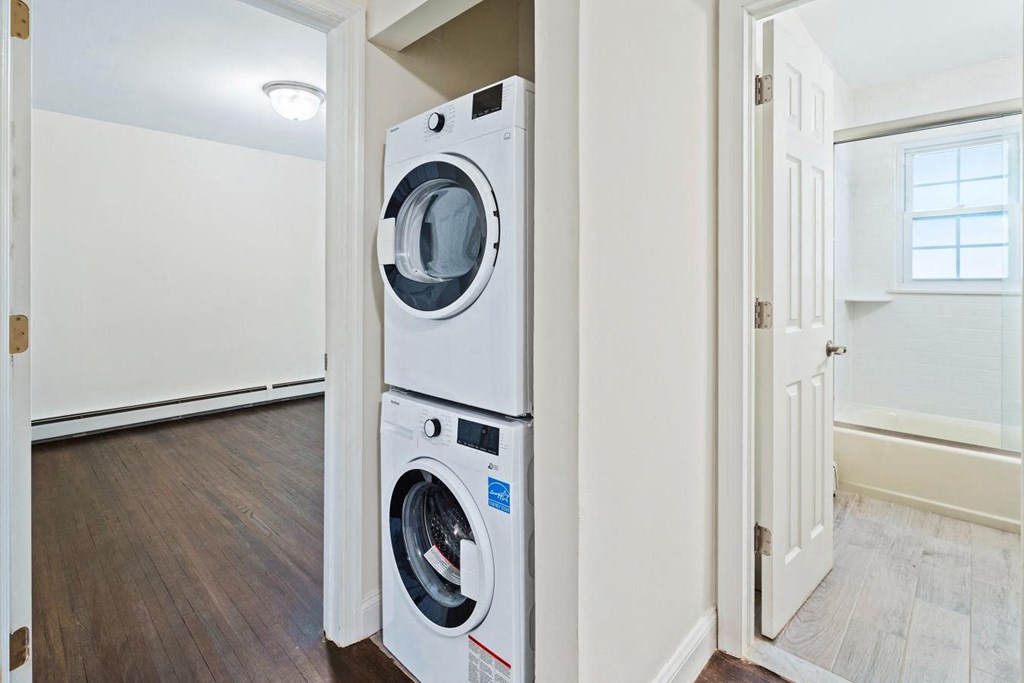 a white laundry room with a washer and dryer in it